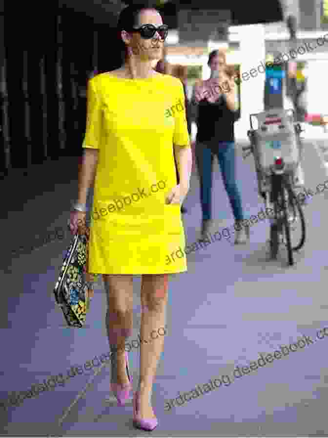 Stretch Sarah Eliza Ankum Speaking At An Event, Wearing A Bright Yellow Dress And A Big Smile. Stretch Sarah Eliza D Ankum